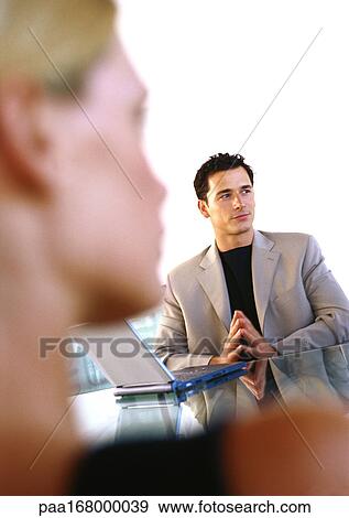 Businessman and woman, focus on businessman with laptop computer View Large Photo Image Stock Photo - Businessman and woman, focus on businessman with laptop computer. Fotosearch