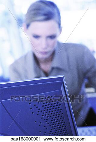 Businesswoman sitting at computer View Large Photo Image Stock Image - Businesswoman sitting at computer. Fotosearch