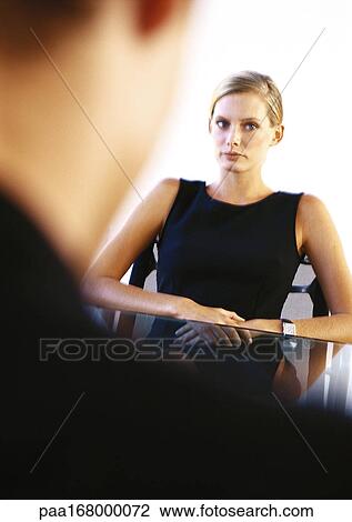 Businesswoman sitting at table across from man View Large Photo Image Stock Image - Businesswoman sitting at table across from man. Fotosearch