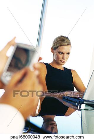 Businesswoman using computer, hands holding pocket computer View Large Photo Image Stock Photo - Businesswoman using computer, hands holding pocket computer. Fotosearch