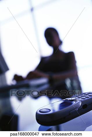 Cell phone on businesswoman's desk, close-up View Large Photo Image Stock Photo - Cell phone on businesswoman's desk, close-up. Fotosearch