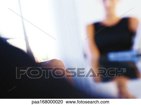 Woman sitting at table, blurred View Large Photo Image Stock Image - Woman sitting at table, blurred. Fotosearch