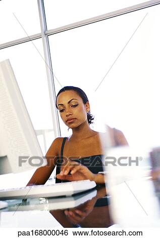 Woman using computer View Large Photo Image Stock Photograph - Woman using computer. Fotosearch