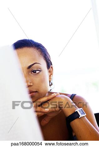 Picture - Woman with hands under chin. Fotosearch