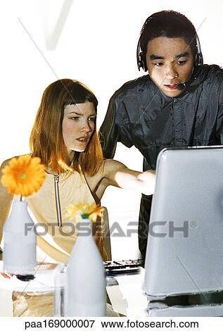 Business people looking at computer screen View Large Photo Image Stock Photo - Business people looking at computer screen. Fotosearch