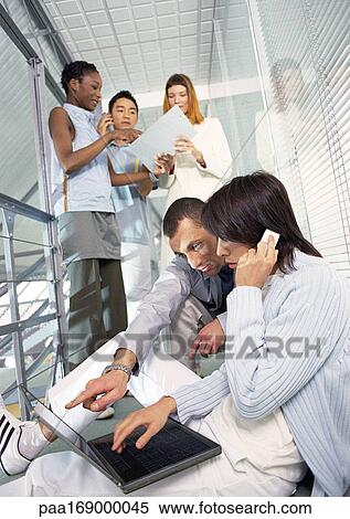 Business people working in office hallway View Large Photo Image Stock Photography - Business people working in office hallway. Fotosearch