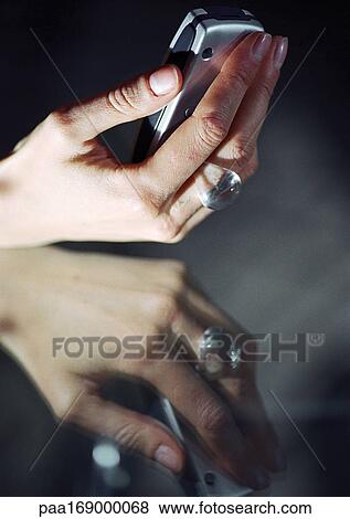 Hand holding cell phone View Large Photo Image Stock Photo - Hand holding cell phone. Fotosearch