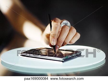 Hand using pocket computer, close-up View Large Photo Image Picture - Hand using pocket computer, close-up. Fotosearch