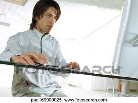 Man at desk using cordless mouse View Large Photo Image Stock Photography - Man at desk using cordless mouse. Fotosearch