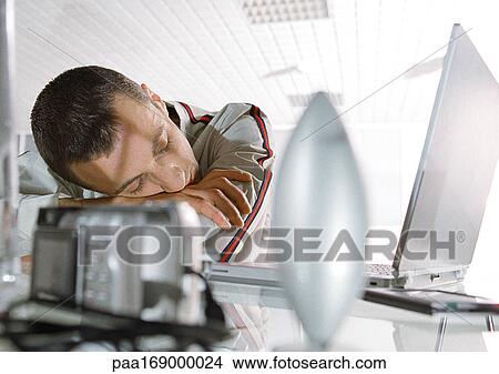 Man sleeping at desk View Large Photo Image Picture - Man sleeping at desk. Fotosearch