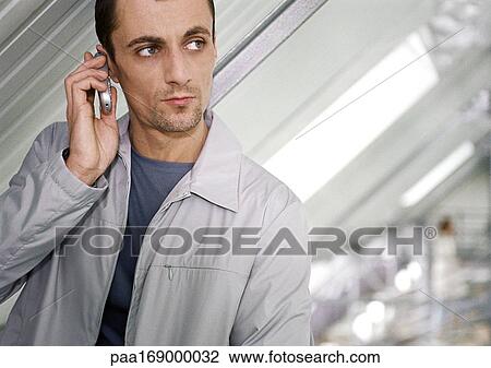 Man using cell phone, head and shoulders View Large Photo Image Stock Image - Man using cell phone, head and shoulders. Fotosearch