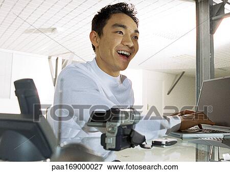 Man using laptop computer, smiling, head and shoulders View Large Photo Image Stock Photo - Man using laptop computer, smiling, head and shoulders. Fotosearch