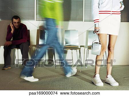 People in room with seats, low section, blurred motion View Large Photo Image Picture - People in room with seats, low section, blurred motion. Fotosearch