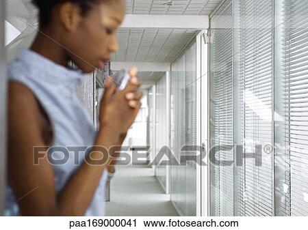 Woman holding futuristic cell phone, side view, blurred View Large Photo Image Stock Image - Woman holding futuristic cell phone, side view, blurred. Fotosearch