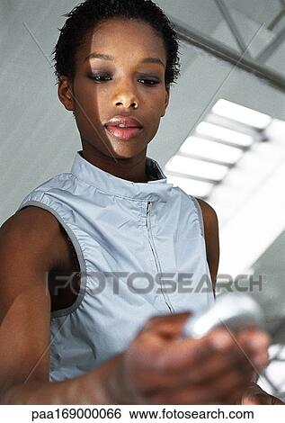 Woman holding futuristic device View Large Photo Image Stock Photograph - Woman holding futuristic device. Fotosearch