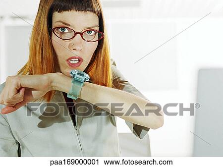 Woman talking to wrist watch View Large Photo Image Stock Image - Woman talking to wrist watch. Fotosearch