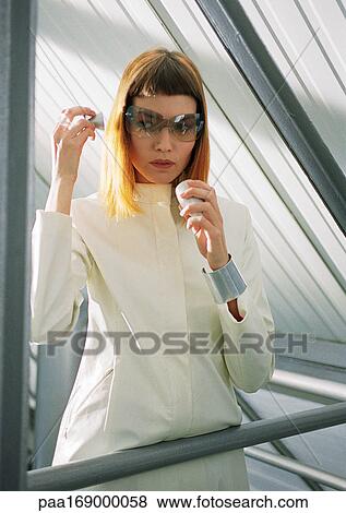 Woman using futuristic cell phone View Large Photo Image Stock Photo - Woman using futuristic cell phone. Fotosearch