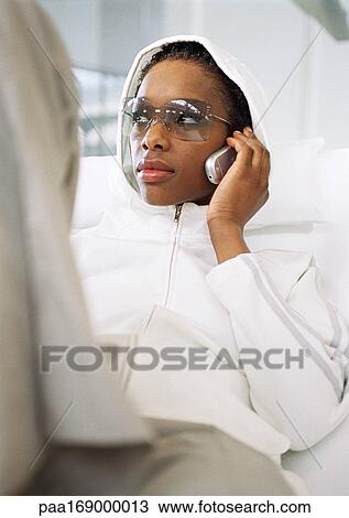 Woman wearing sportswear, using cell phone View Large Photo Image Stock Image - Woman wearing sportswear, using cell phone. Fotosearch