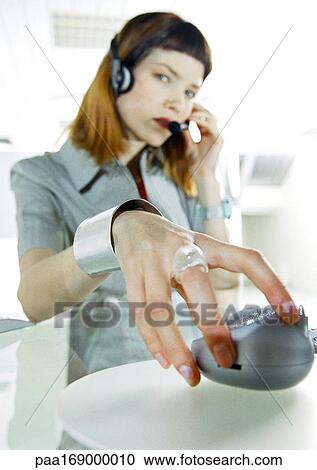 Woman with headset holding futuristic device View Large Photo Image Stock Image - Woman with headset holding futuristic device. Fotosearch