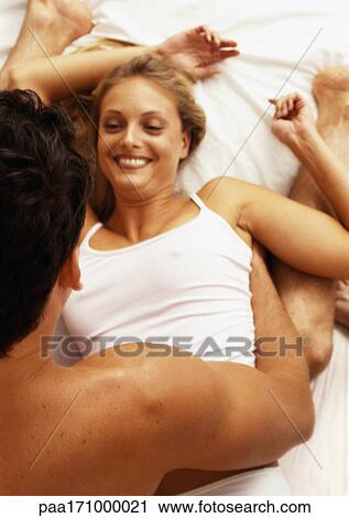 Couple in bed, close-up View Large Photo Image Stock Image - Couple in bed, close-up. Fotosearch