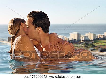 Couple kissing in swimming pool View Large Photo Image Stock Image - Couple kissing in swimming pool. Fotosearch