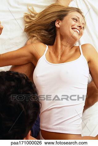 Stock Photograph - Couple lying on bed. Fotosearch