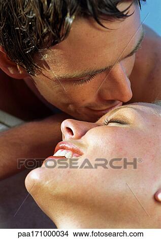 Couple smiling, man about to kiss woman's forehead, close-up View Large Photo Image Picture - Couple smiling, man about to kiss woman's forehead, close-up. Fotosearch