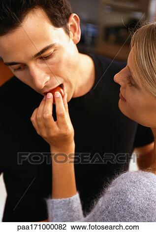 Woman feeding man cherry tomato View Large Photo Image Stock Image - Woman feeding man cherry tomato. Fotosearch