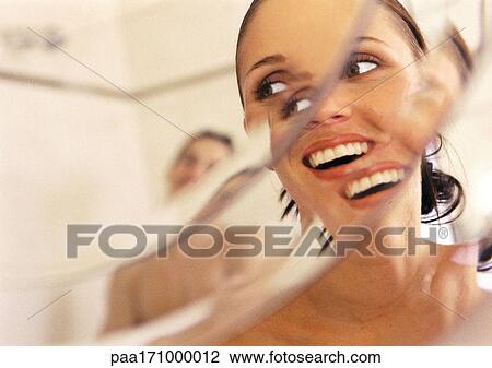 Woman looking at man in mirror, close-up, smiling, distortion View Large Photo Image Stock Image - Woman looking at man in mirror, close-up, smiling, distortion. Fotosearch