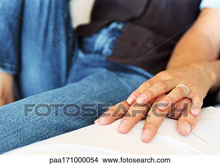 Woman's hand on man's hand, close-up View Large Photo Image Picture - Woman's hand on man's hand, close-up. Fotosearch