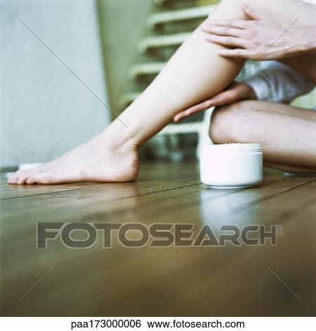 Woman applying cream to legs, close-up View Large Photo Image Stock Photograph - Woman applying cream to legs, close-up. Fotosearch