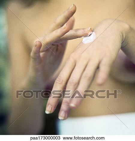 Woman applying lotion on hands, close-up View Large Photo Image Stock Image - Woman applying lotion on hands, close-up. Fotosearch