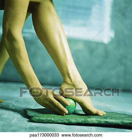 Woman holding apple under heel, low section View Large Photo Image Stock Image - Woman holding apple under heel, low section. Fotosearch