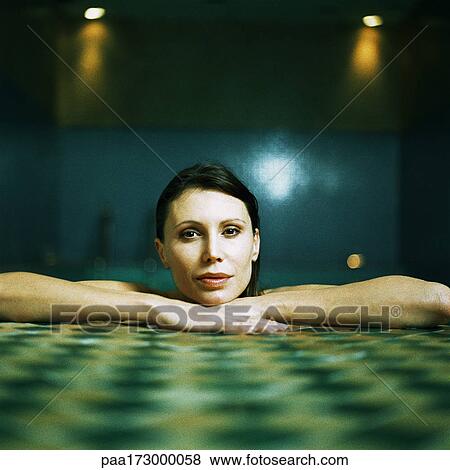 Woman resting arms and head on side of pool, portrait View Large Photo Image Stock Photo - Woman resting arms and head on side of pool, portrait. Fotosearch