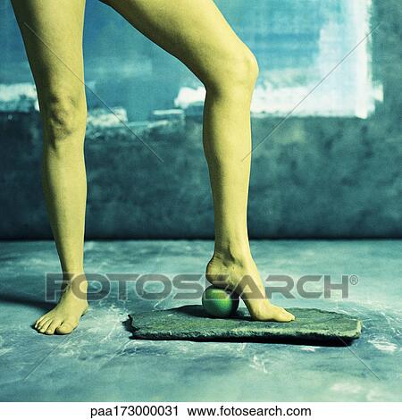 Woman standing with heel on apple, low section View Large Photo Image Stock Image - Woman standing with heel on apple, low section. Fotosearch