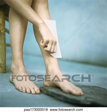 Woman waxing leg, low section View Large Photo Image Stock Photo - Woman waxing leg, low section. Fotosearch