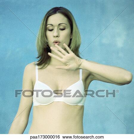 Woman wearing bra, blowing on nails, waist up View Large Photo Image Stock Photograph - Woman wearing bra, blowing on nails, waist up. Fotosearch