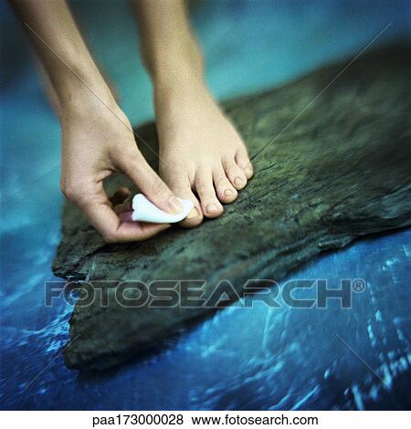 Stock Photo - Woman's hand removing toenail polish. Fotosearch