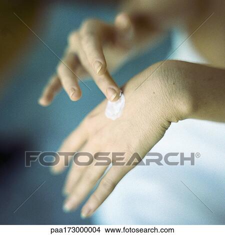 Woman's hands, applying moisturizer, blurred, close-up View Large Photo Image Picture - Woman's hands, applying moisturizer, blurred, close-up. Fotosearch