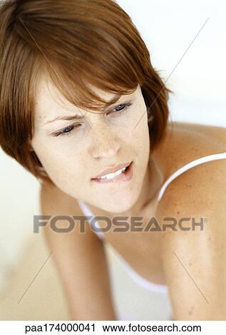 Woman biting her lip, close-up View Large Photo Image Stock Image - Woman biting her lip, close-up. Fotosearch