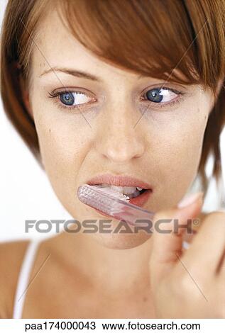 Stock Image - Woman brushing teeth, close-up. Fotosearch