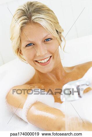 Woman in bathtub, smiling at camera, head and shoulders View Large Photo Image Stock Photo - Woman in bathtub, smiling at camera, head and shoulders. Fotosearch