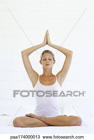 Woman in meditative position, full length, white background View Large Photo Image Stock Image - Woman in meditative position, full length, white background. Fotosearch