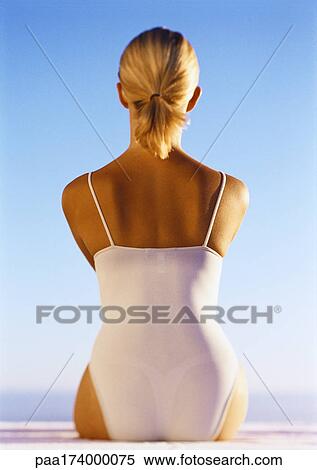 Woman in swimsuit sitting outdoors, rear view View Large Photo Image Stock Photography - Woman in swimsuit sitting outdoors, rear view. Fotosearch