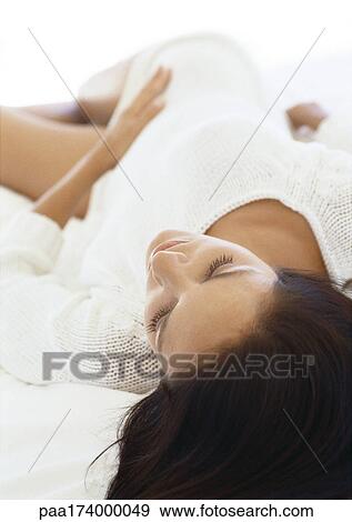 Stock Photo - Woman lying on bed. Fotosearch