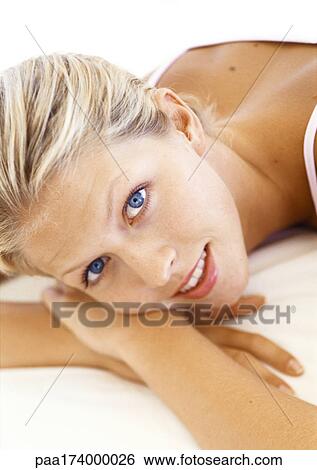 Woman lying on stomach, close up View Large Photo Image Stock Photograph - Woman lying on stomach, close up. Fotosearch