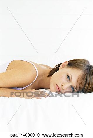 Woman lying on stomach, portrait, close-up View Large Photo Image Stock Image - Woman lying on stomach, portrait, close-up. Fotosearch