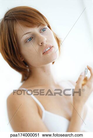Woman putting on perfume View Large Photo Image Stock Image - Woman putting on perfume. Fotosearch