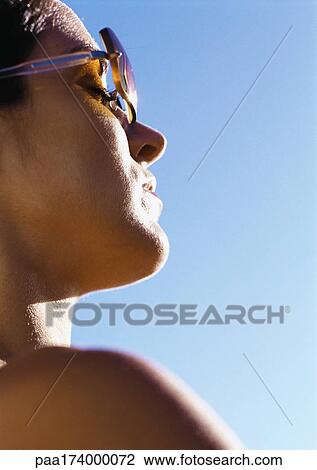 Woman wearing sunglasses, close-up View Large Photo Image Stock Image - Woman wearing sunglasses, close-up. Fotosearch