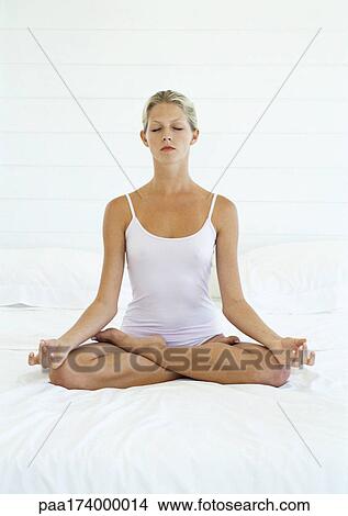Woman with eyes closed in lotus position, full length, white background View Large Photo Image Picture - Woman with eyes closed in lotus position, full length, white background. Fotosearch